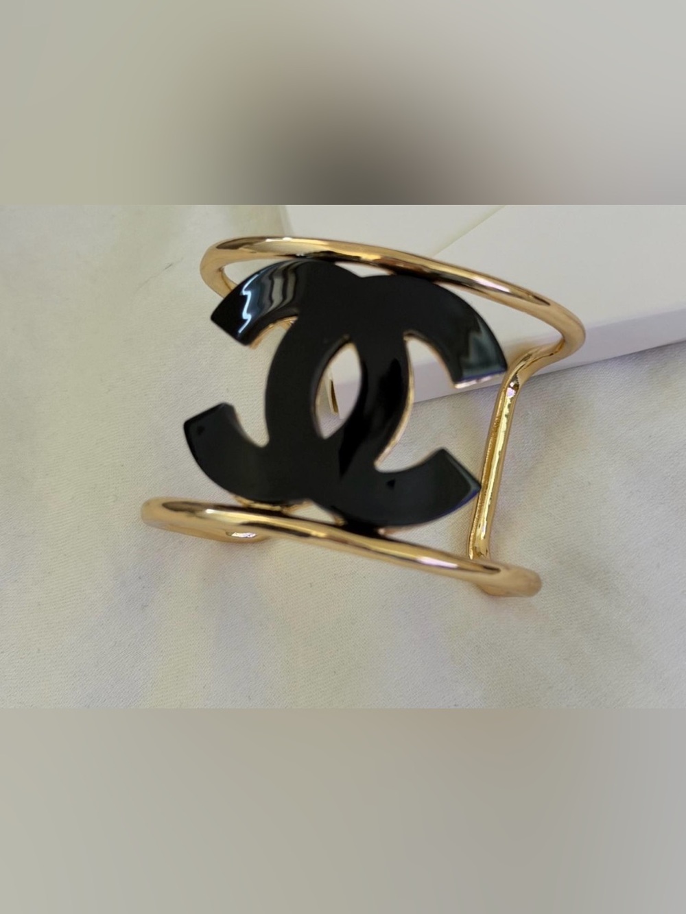 CHANEL Gold Tone Cuff Bracelet with Black CC Logo